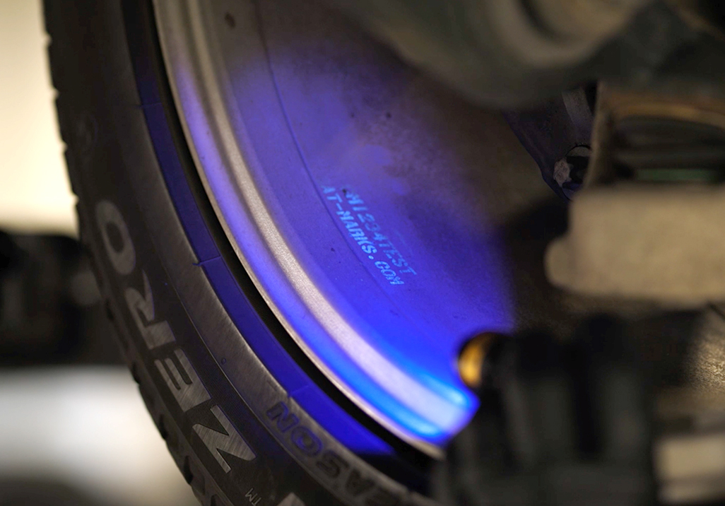Blue UV light shining on the inside of a car rim.